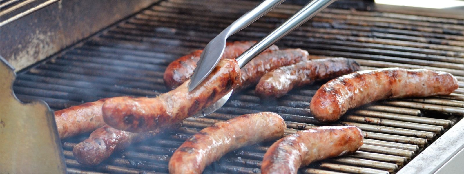 Outdoor grill cooking bratwurst Outdoor grill cooking bratwurst